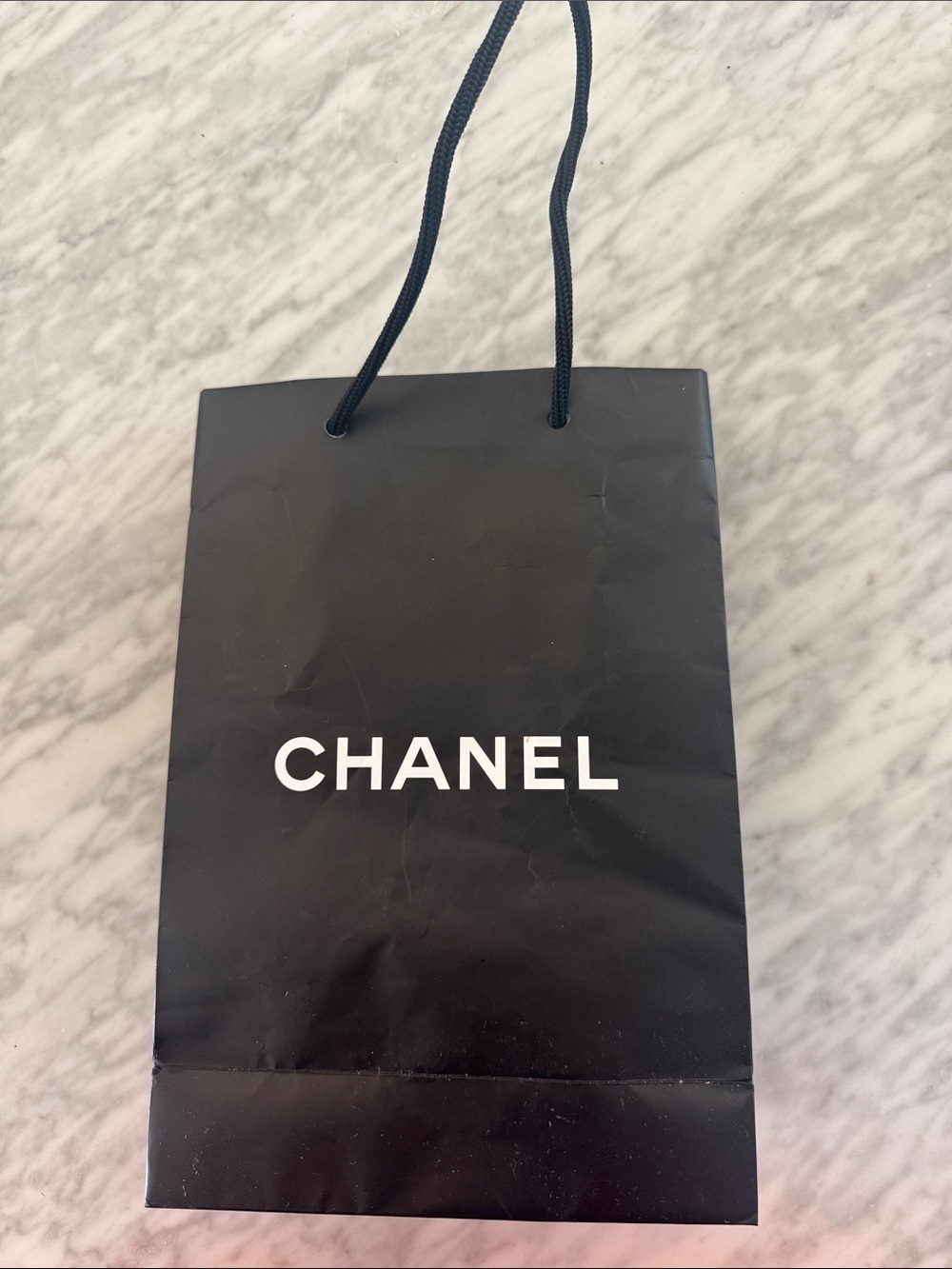 Chanel black logo matte paper gift bag + bonus eye makeup instruction booklet.